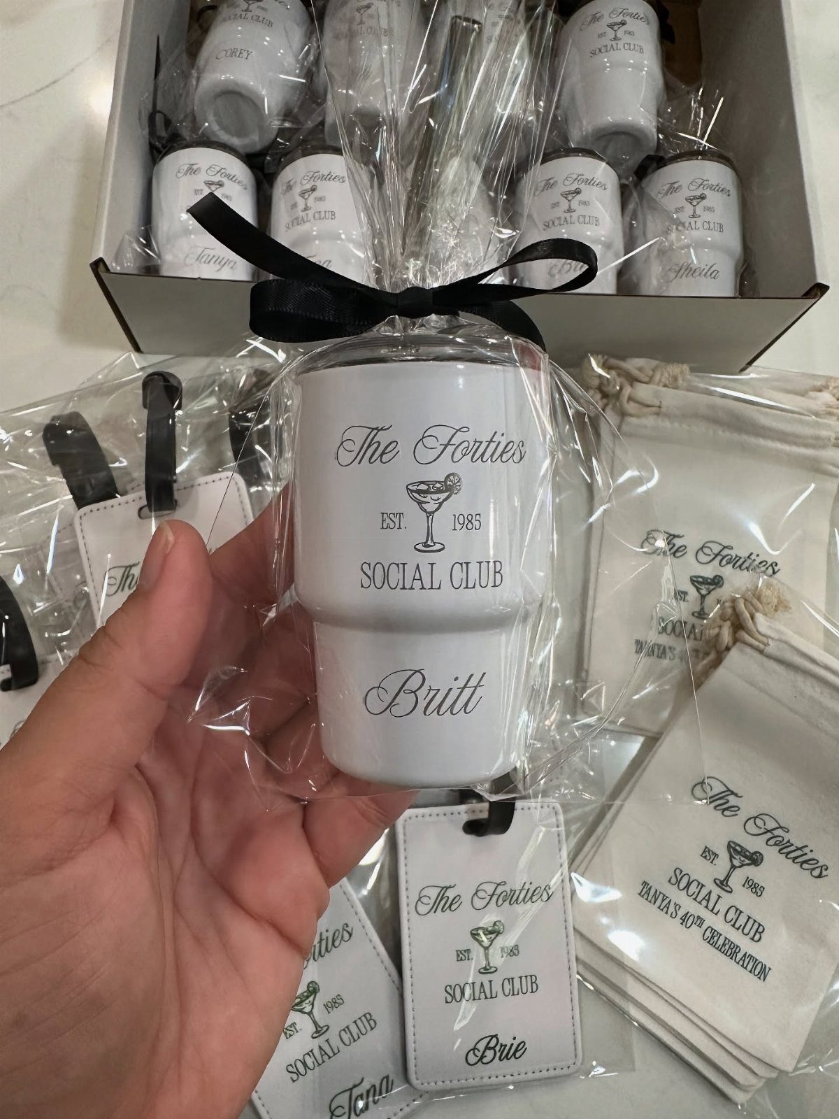 Custom white glasses and napkins for a 40th birthday social club celebration.