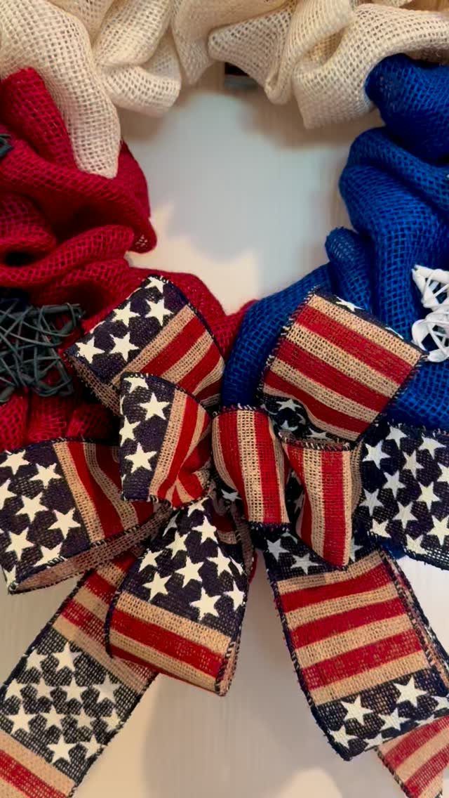 Patriotic red, white, and blue burlap wreath with a large stars and stripes bow.