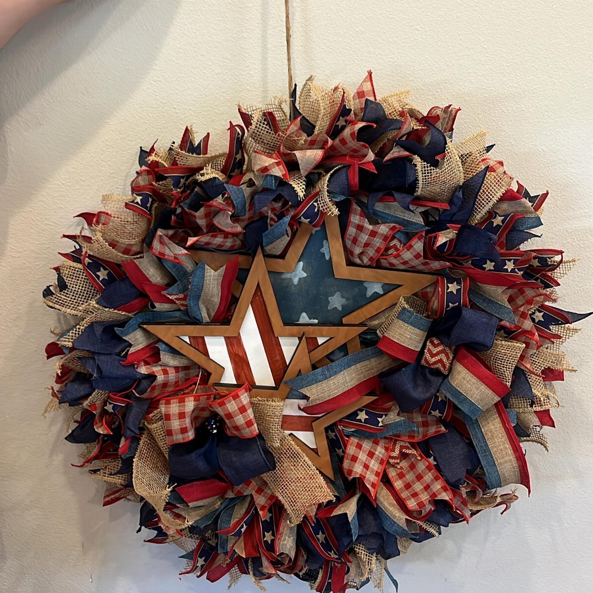 Patriotic 4th of July wreath with red, white, and blue fabric and wooden star