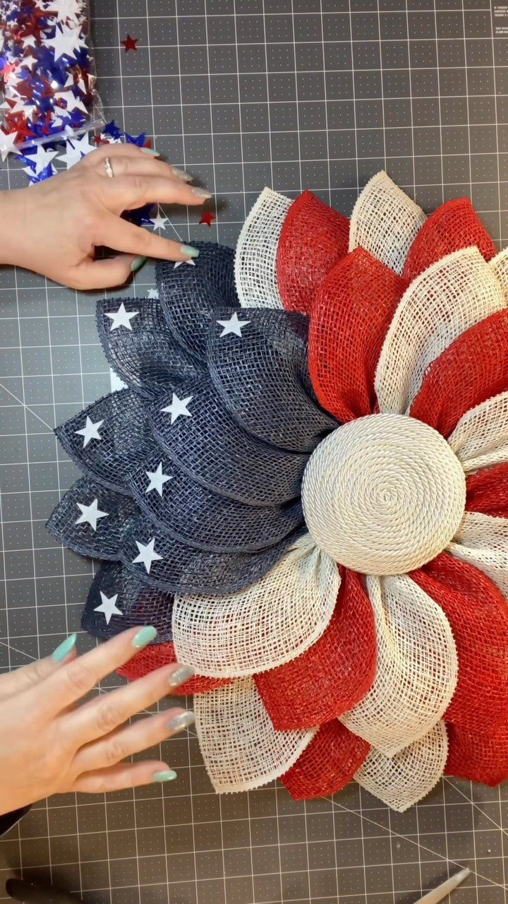 Patriotic burlap wreath with red, white, and blue petals and white stars.