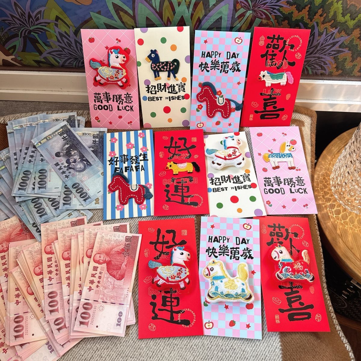 Red and colorful envelopes with horse decorations and Chinese banknotes on a table.