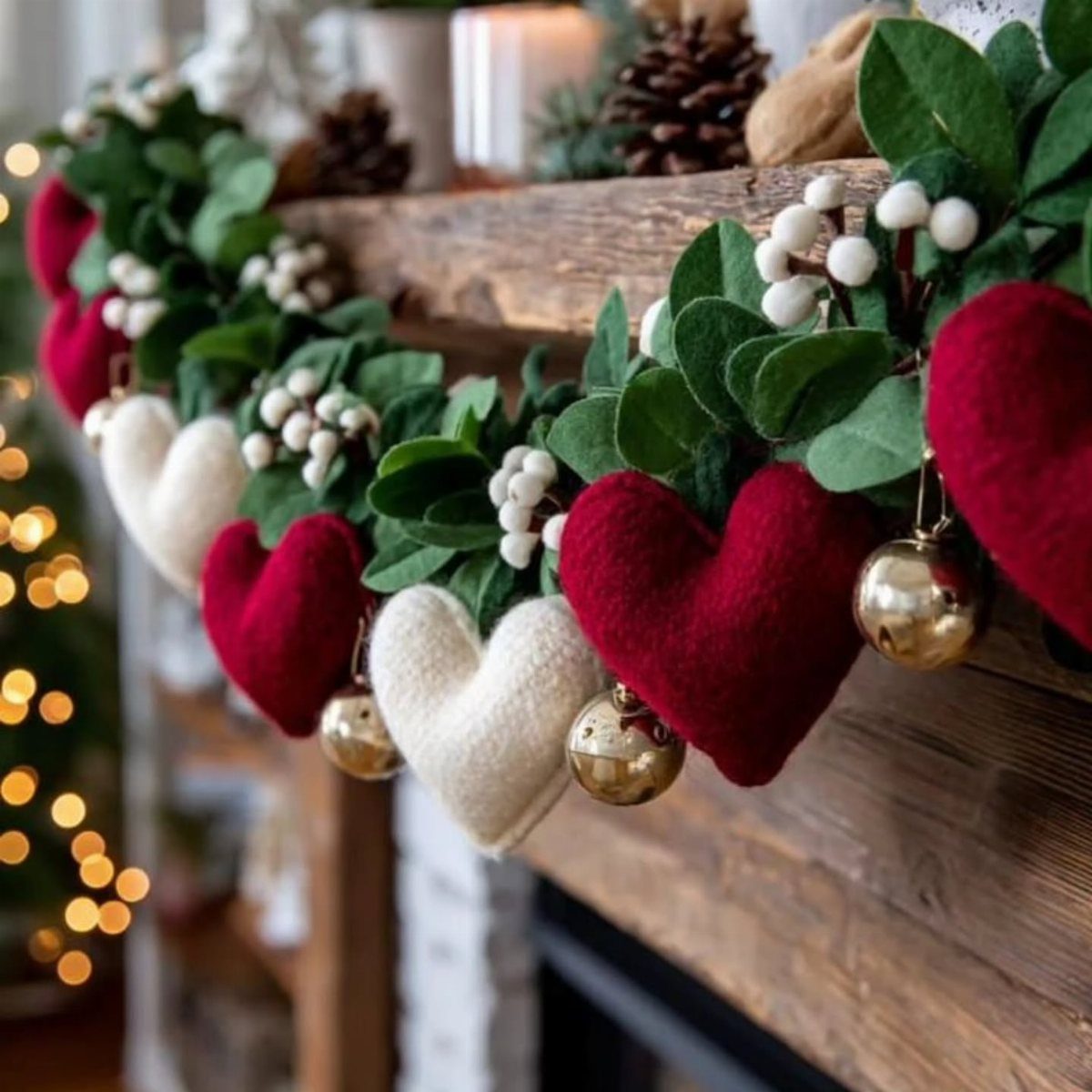 Festive garland with red and white felt hearts on a wooden mantel