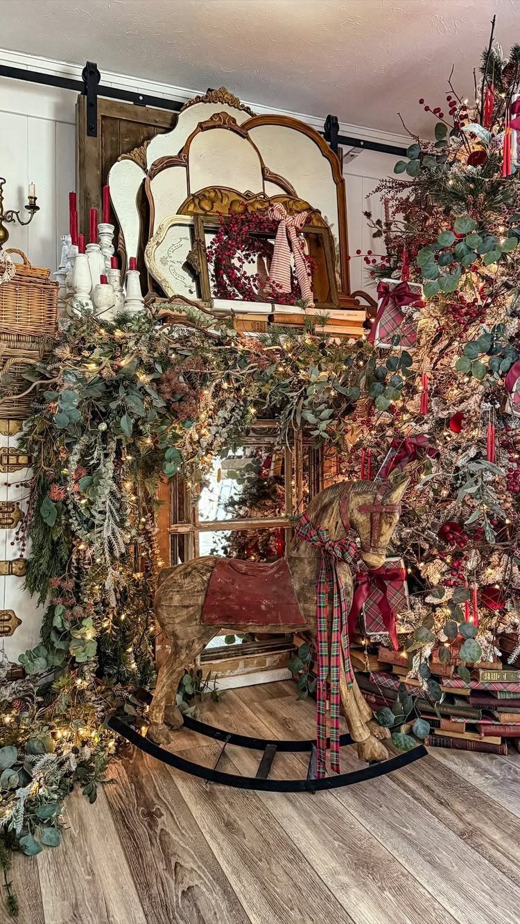 Wooden rocking horse with plaid bow surrounded by Christmas garlands and a decorated tree.