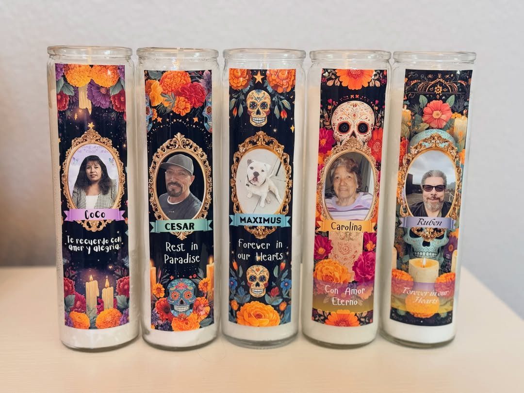 Five personalized Day of the Dead prayer candles with portraits and orange marigolds.