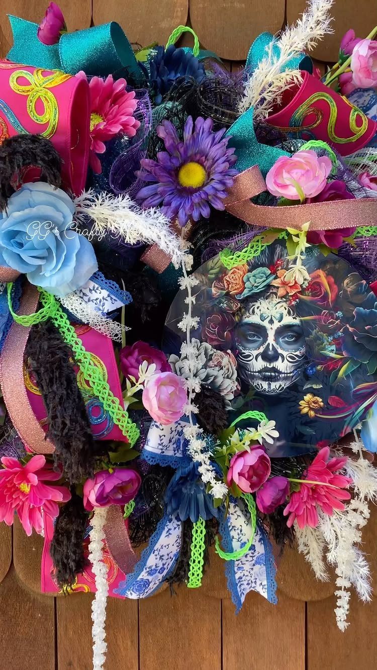 Day of the Dead wreath with colorful faux flowers and sugar skull imagery.