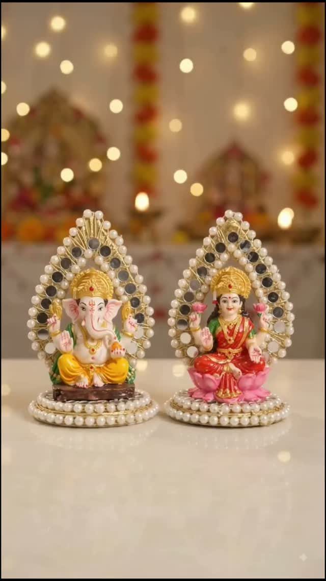 Idols of Ganesha and Lakshmi with pearl frames against a bokeh light background