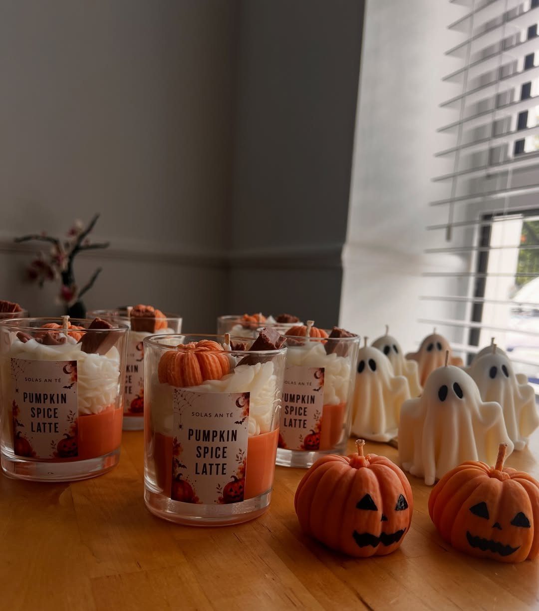 Pumpkin spice latte candles in glass jars with ghost and pumpkin candles.