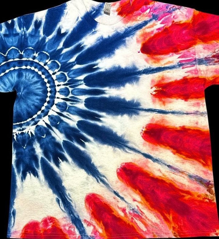 White t-shirt with a red, white, and blue tie-dye spiral pattern.