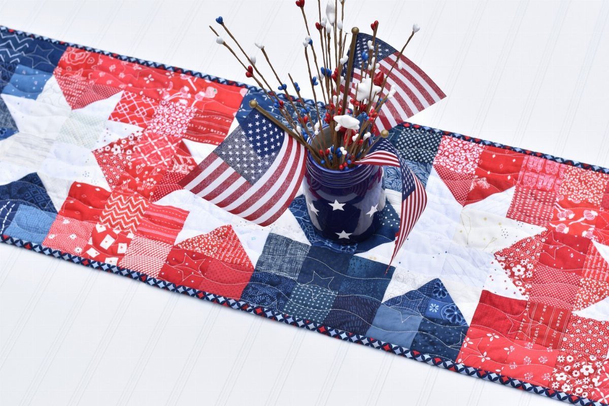 Quilted red, white, and blue star table runner with patriotic jar centerpiece