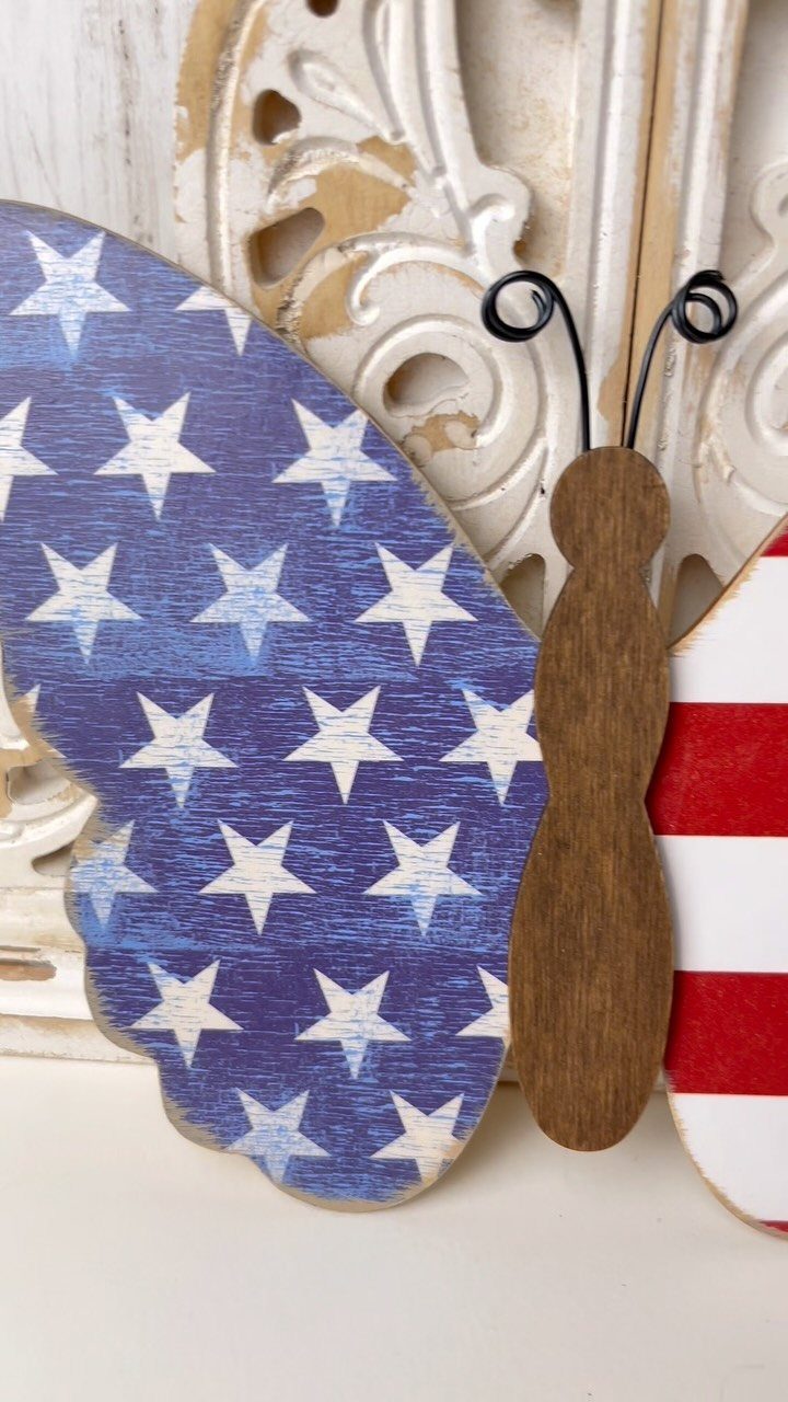 Wooden butterfly decoration painted with American flag stars and stripes on white background