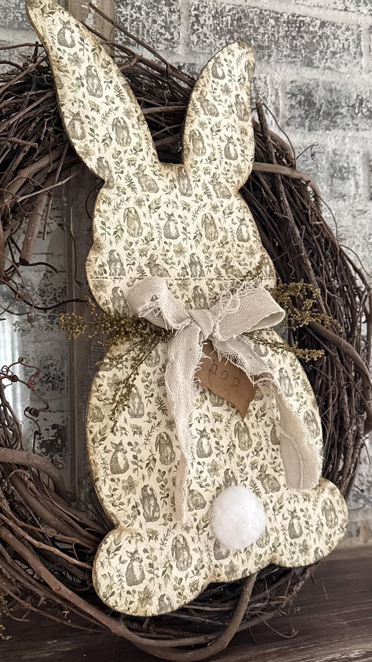 Bunny-shaped fabric cutout with a lace bow inside a rustic grapevine wreath