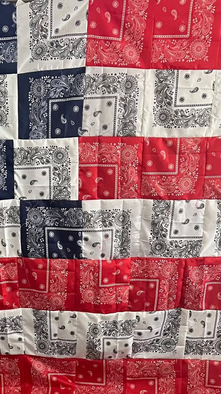 Red, white, and blue paisley bandana fabric arranged in a striped flag pattern.