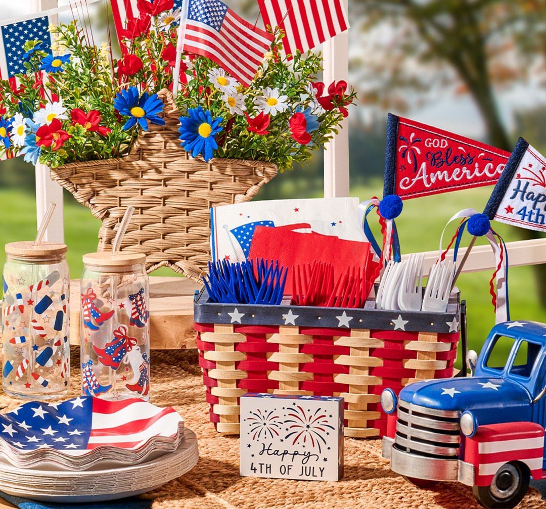 Fourth of July table decorations with American flags, red white and blue tableware.
