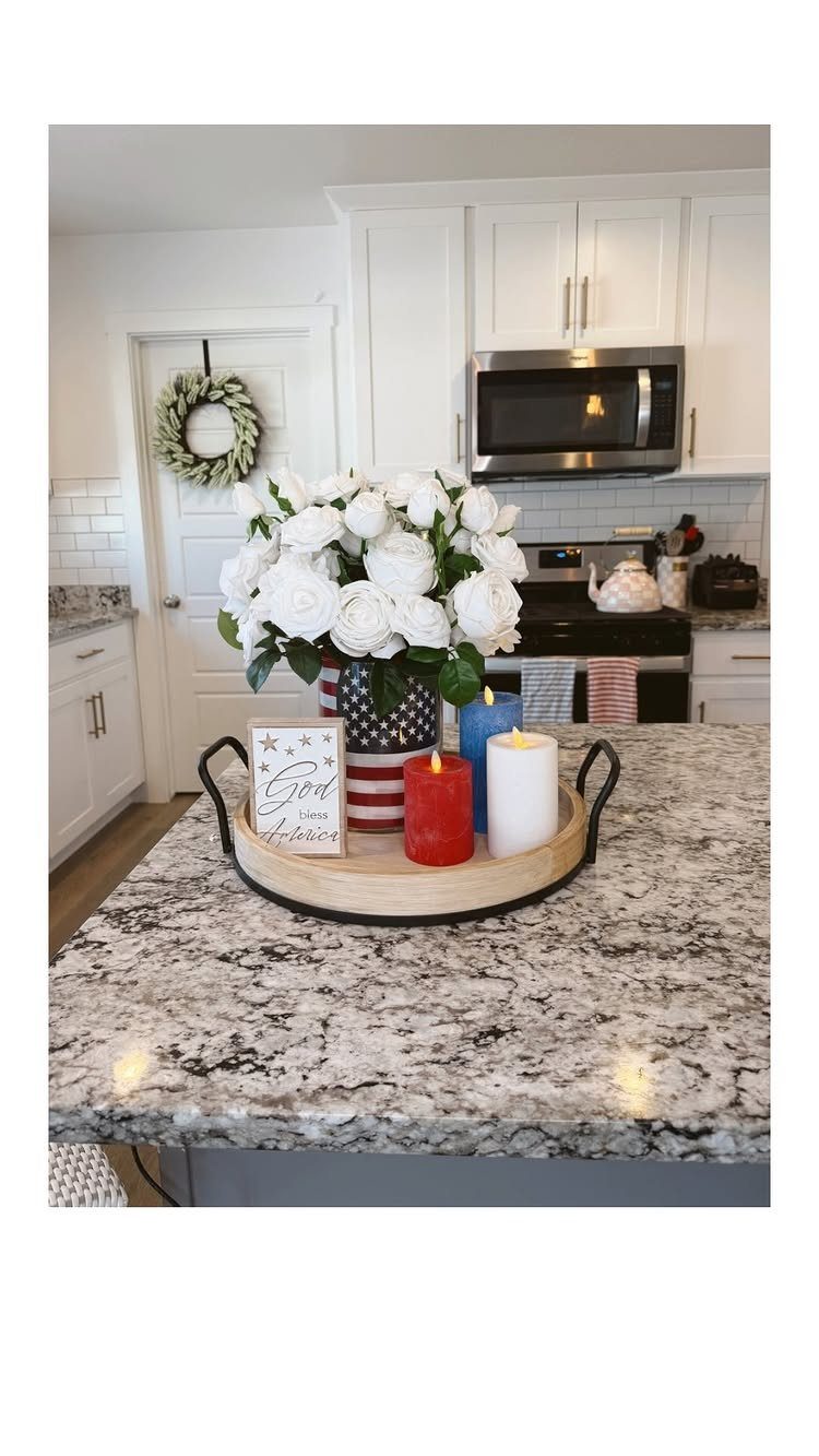 Patriotic red white and blue decorations with white roses on a kitchen counter