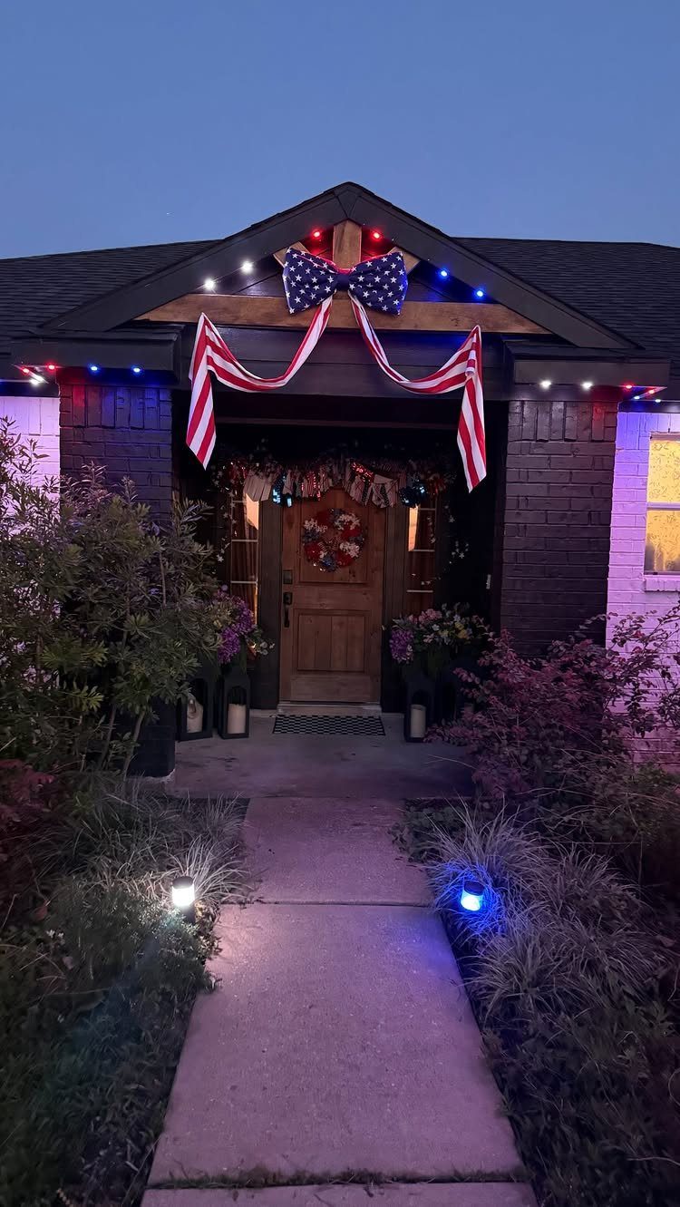 House entrance decorated with red white and blue bunting and festive outdoor lighting