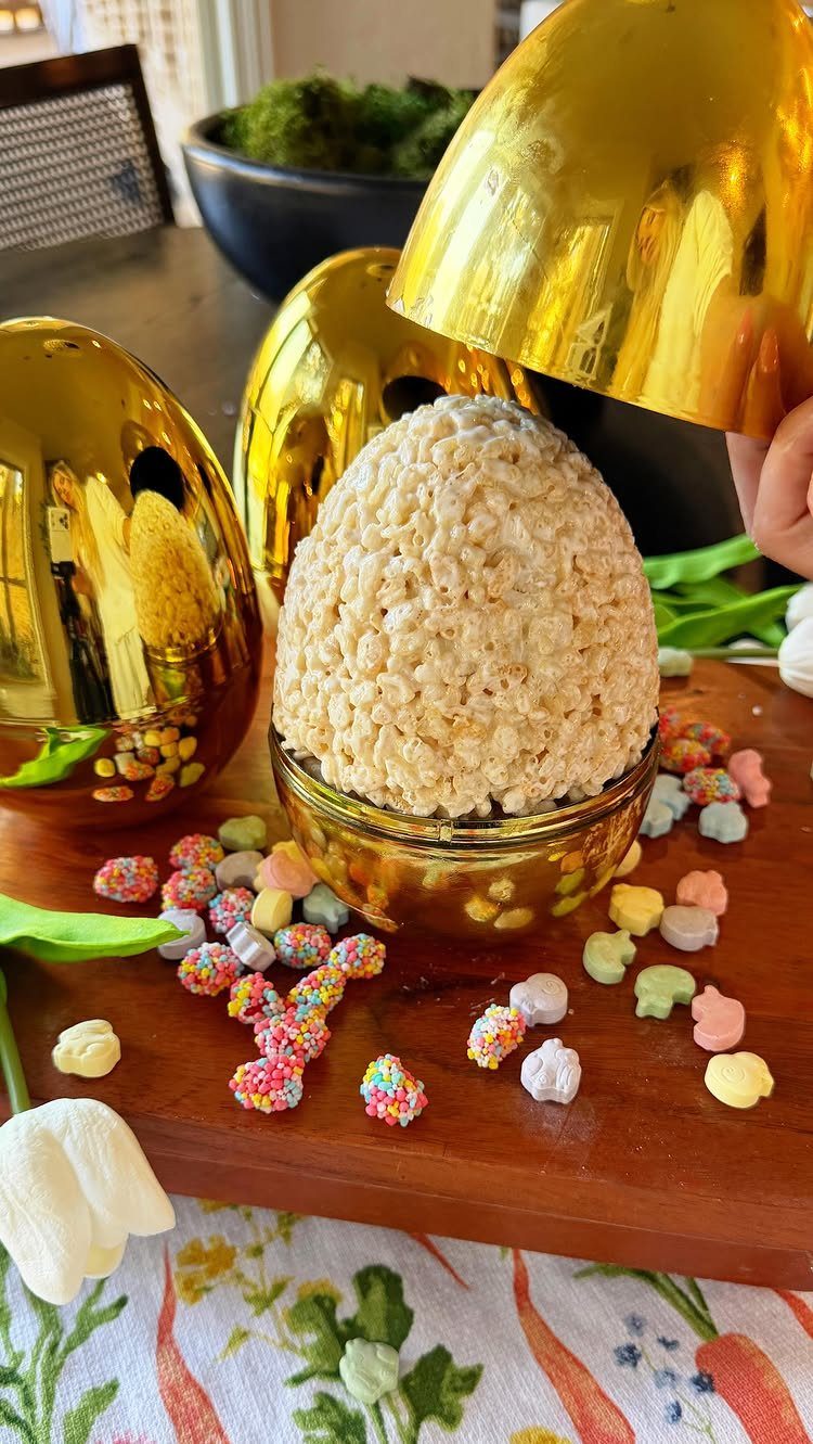 Egg-shaped Rice Krispie treat in a glass bowl with colorful marshmallow Peeps.