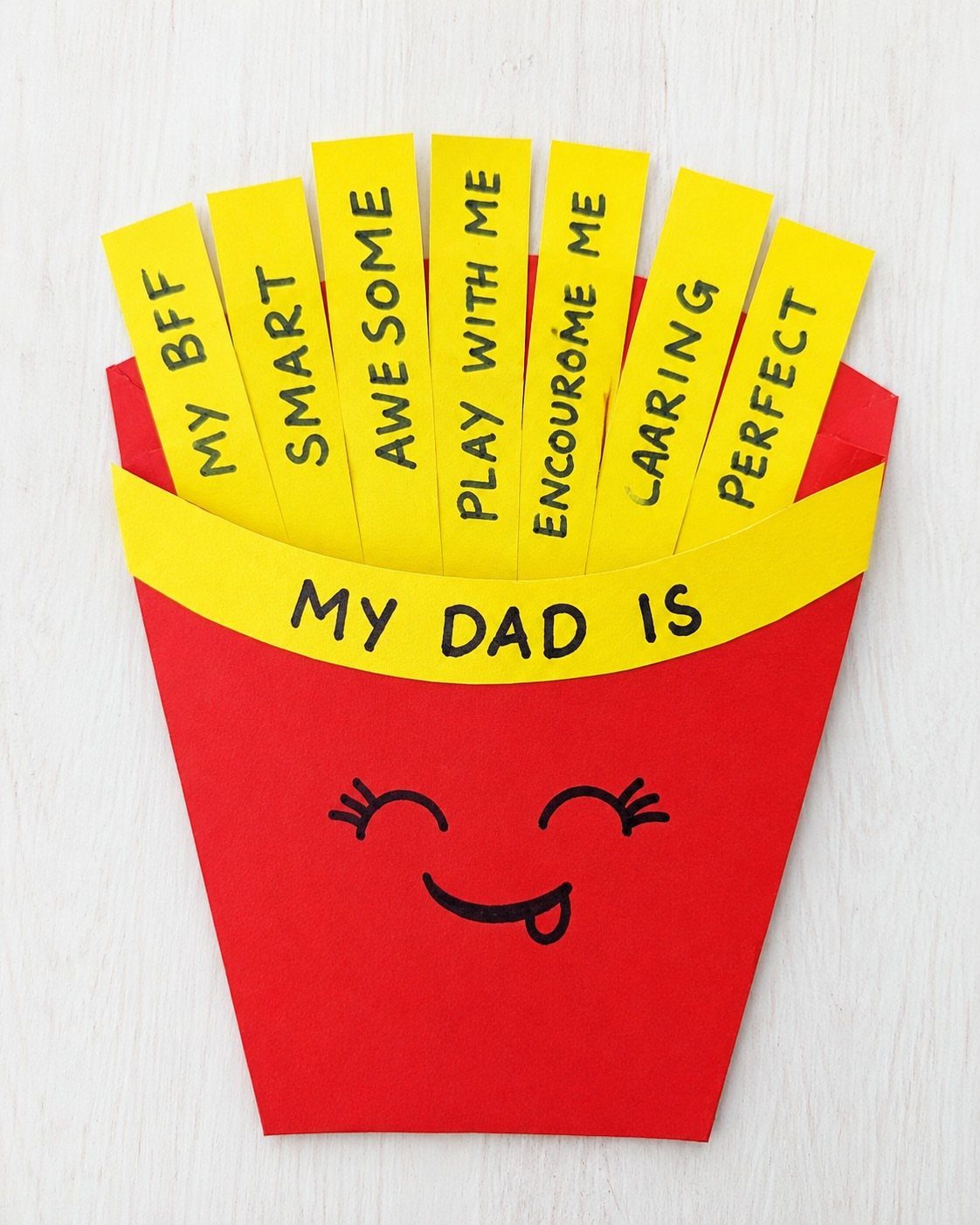 Handmade red french fry container craft with yellow paper strips for Father's Day.