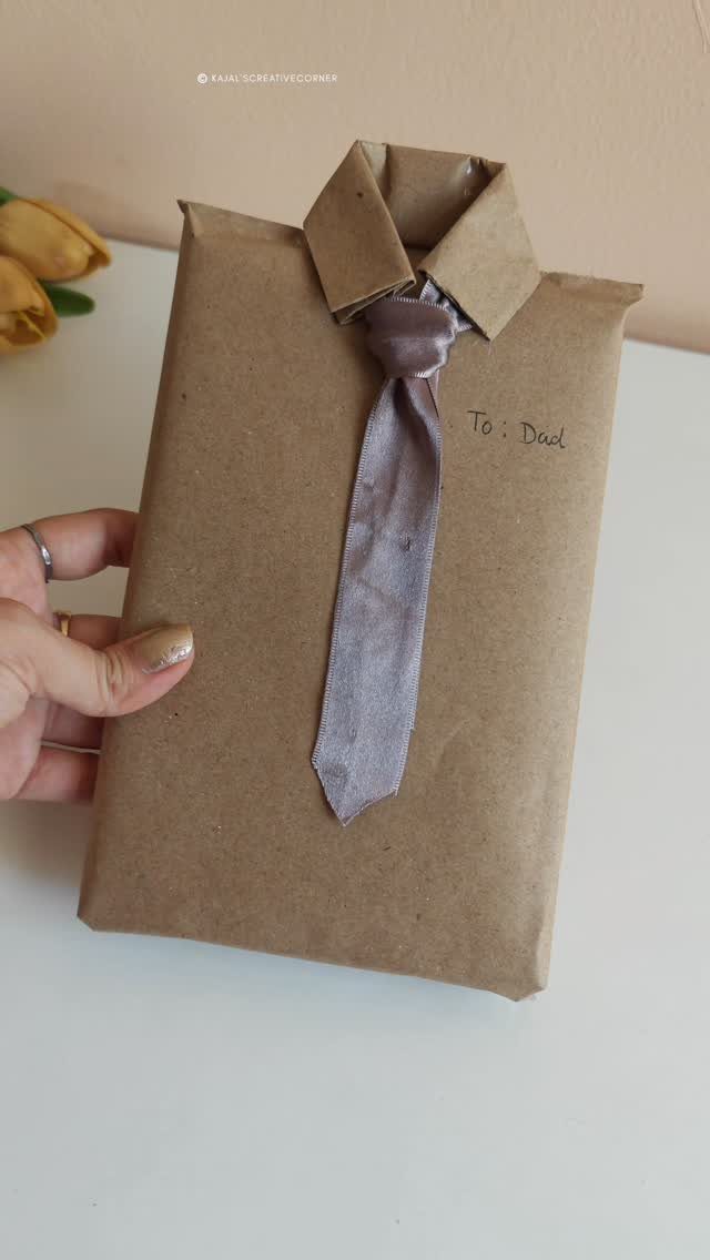 Brown paper gift wrapped as a shirt with a grey tie for Dad