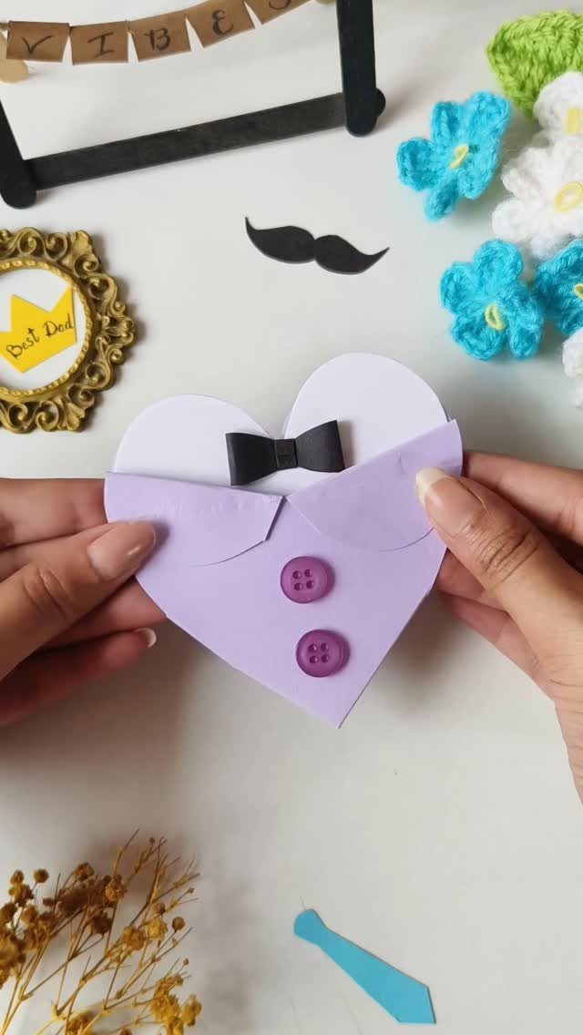 Heart-shaped purple card designed as a shirt with a black bowtie and buttons.