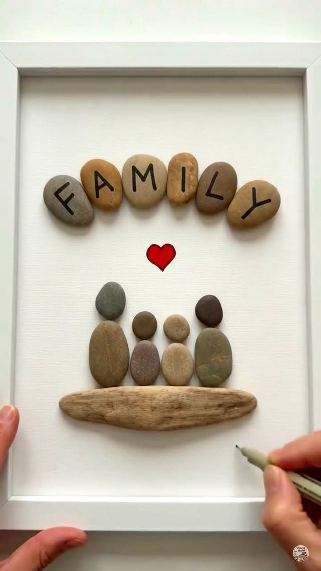Stone family art in a white frame with the word FAMILY and a heart.