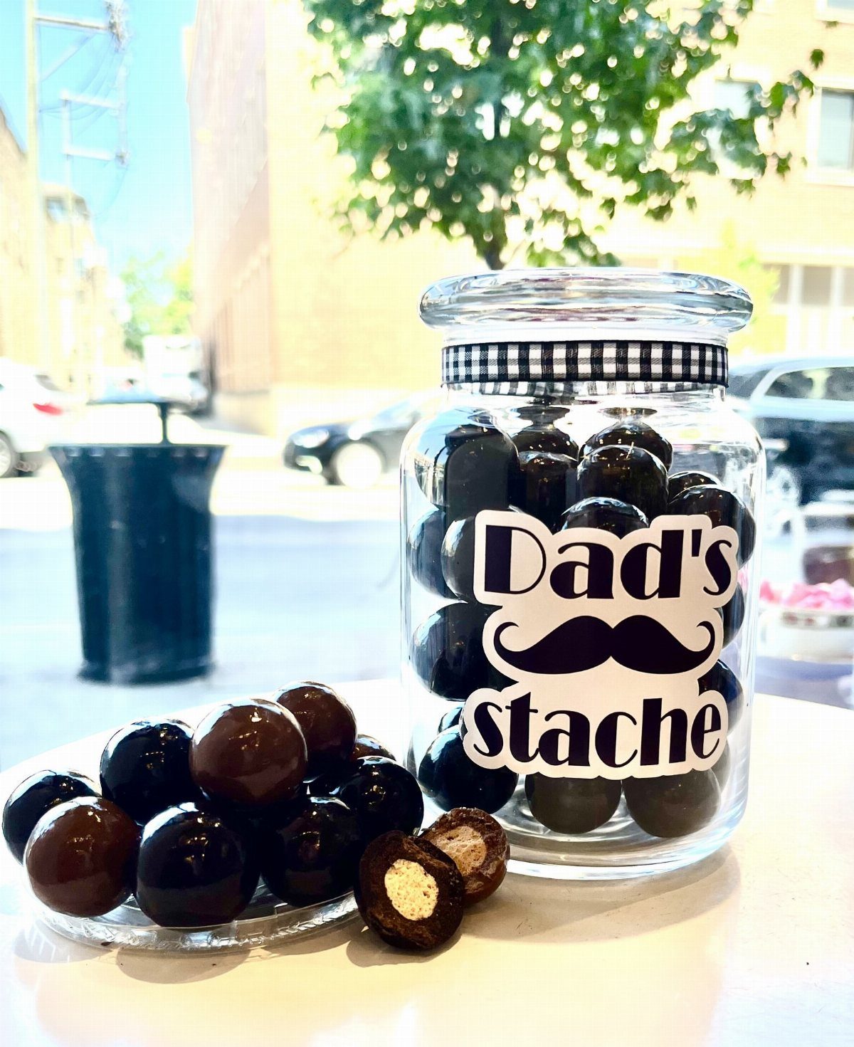 Glass jar of chocolates with a Dad's stache label and mustache illustration.