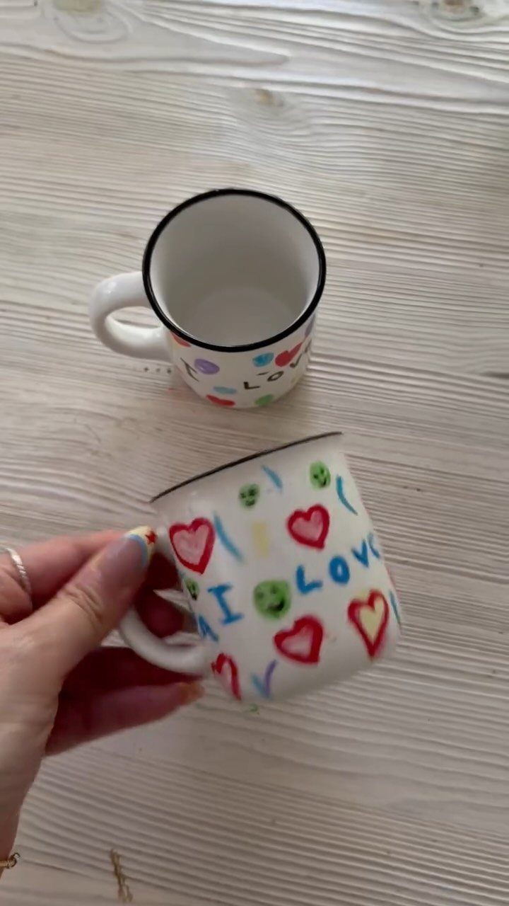 Two white porcelain mugs decorated with colorful hand-drawn hearts and I LOVE text.