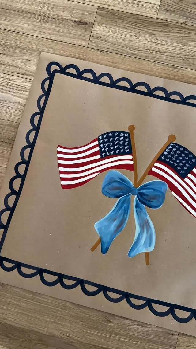 Painting of two American flags tied with a blue bow on tan canvas.