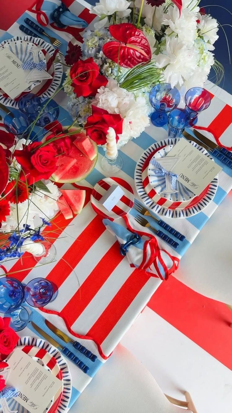 Festive Fourth of July table setting with layered red and white striped linens.