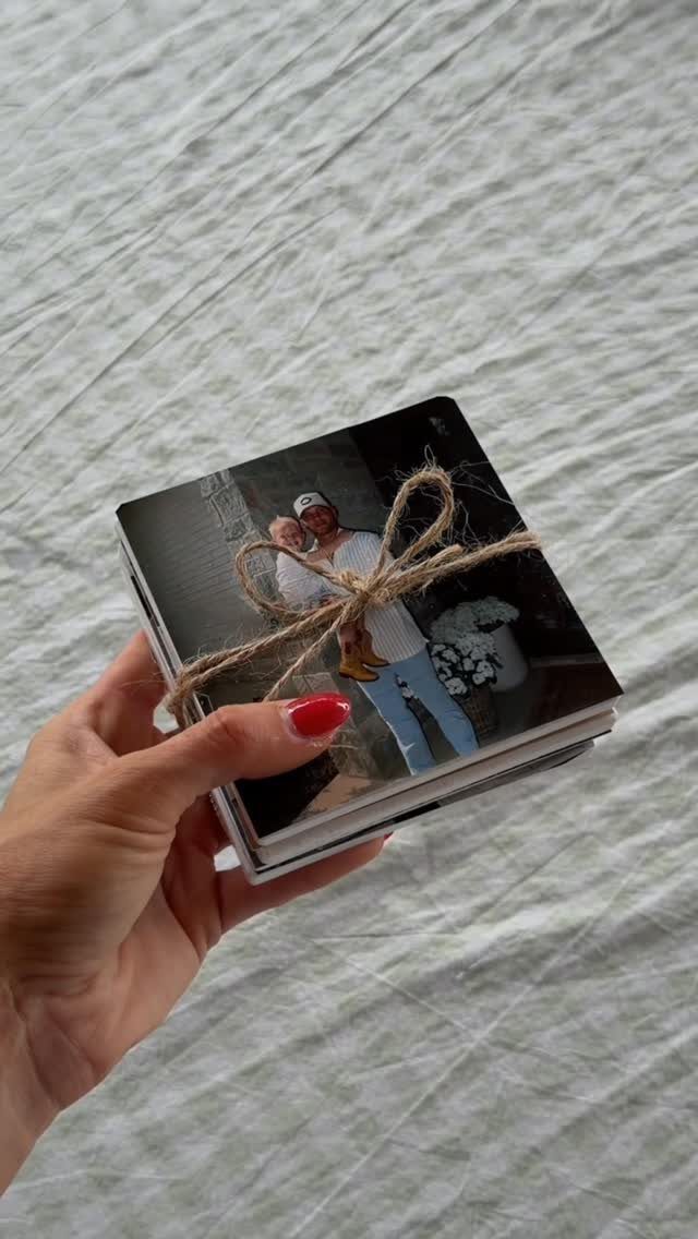 Handmade photo album tied with twine featuring a father and child hugging.