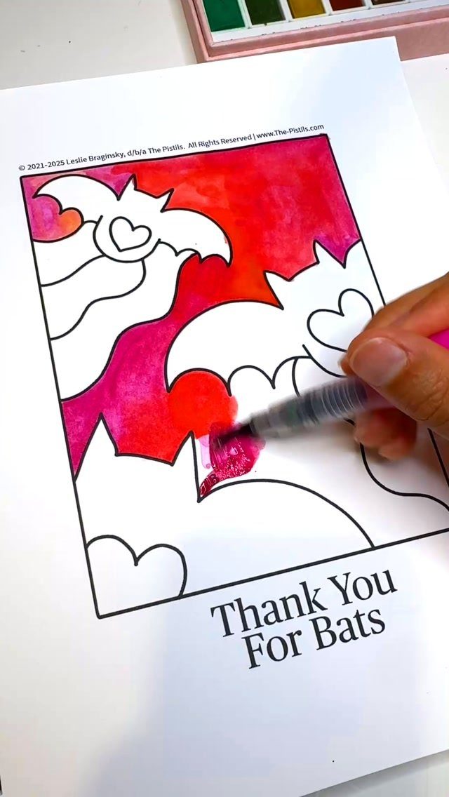 Hand painting a Halloween bat coloring page with red and pink watercolors