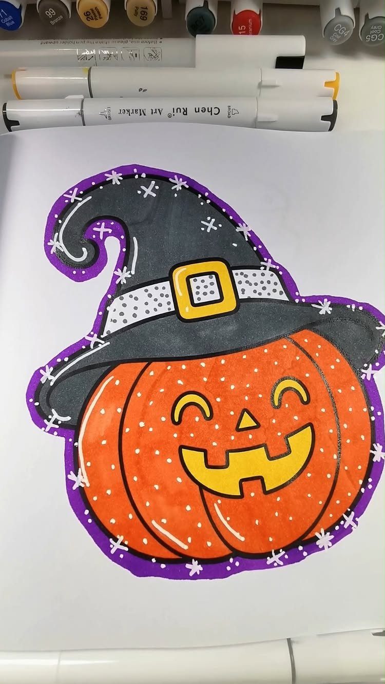 Colored drawing of a smiling pumpkin wearing a black witch hat on white paper