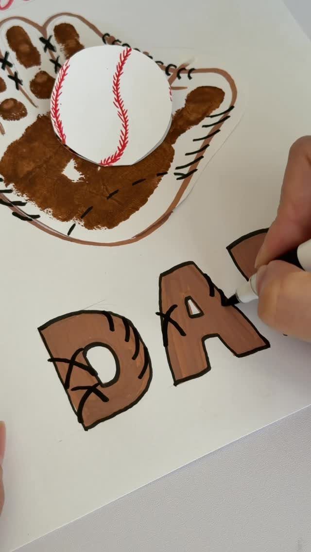Handprint art shaped like a baseball glove with a paper baseball and 'DAD' text.