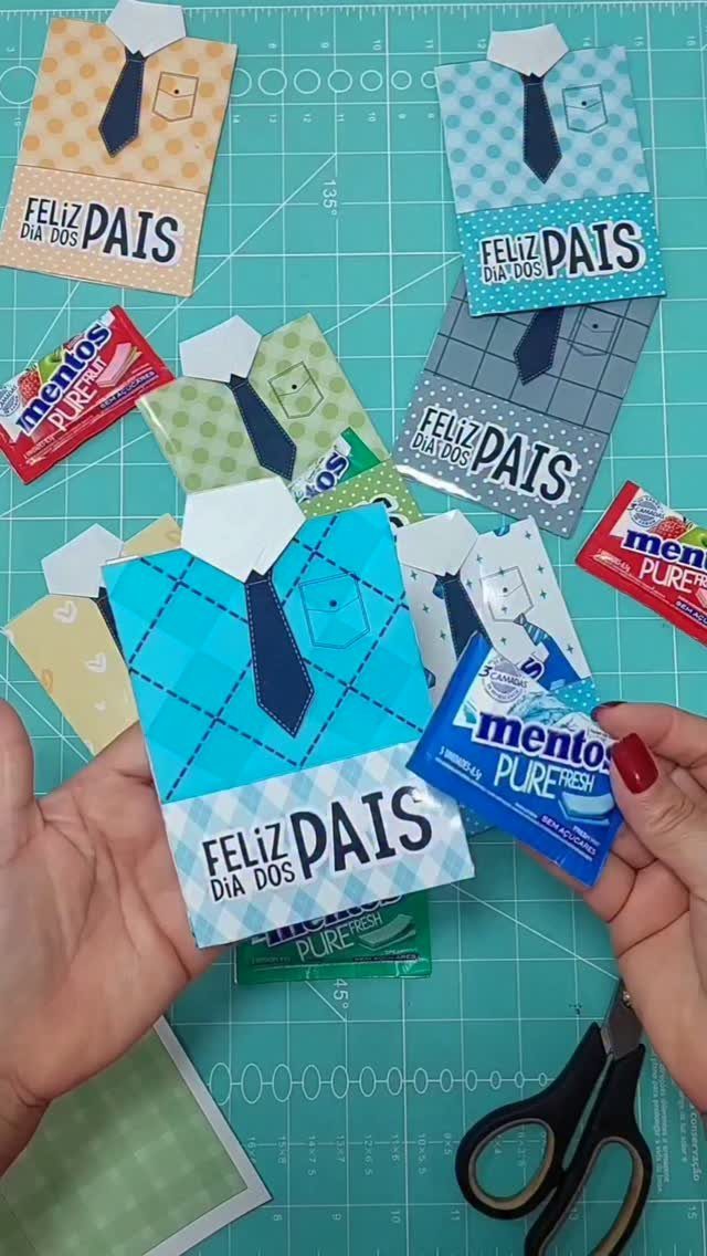 Blue patterned paper shirt craft with a tie and Father's Day text in Portuguese.