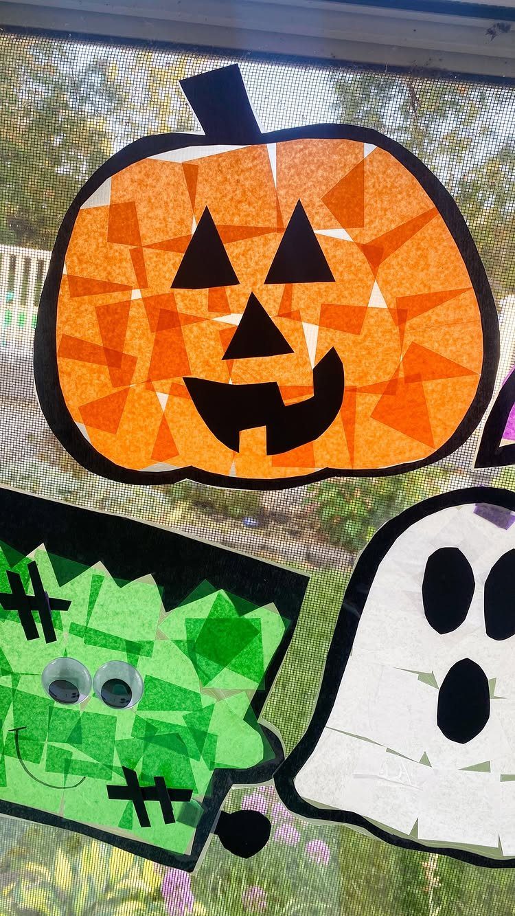 Halloween suncatchers of a pumpkin, Frankenstein, and ghost on a window pane
