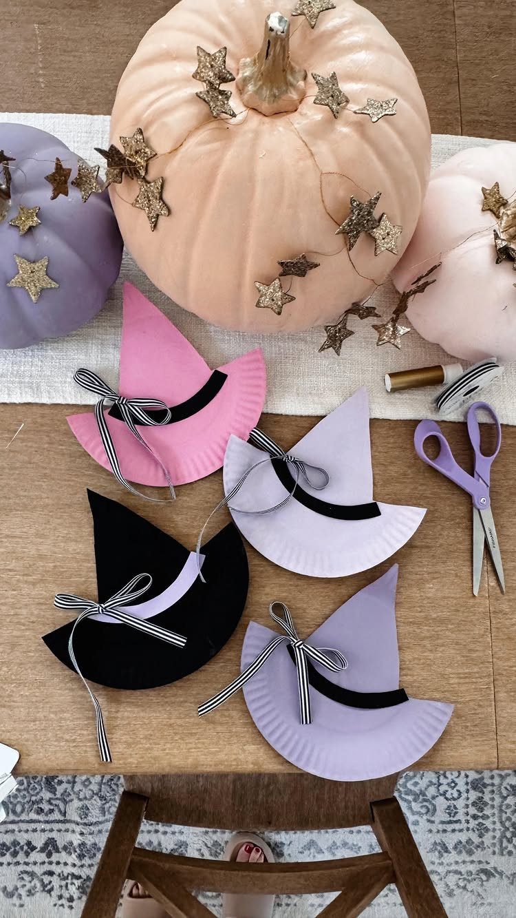 Paper plate witch hats and pastel pumpkins with gold stars on a table
