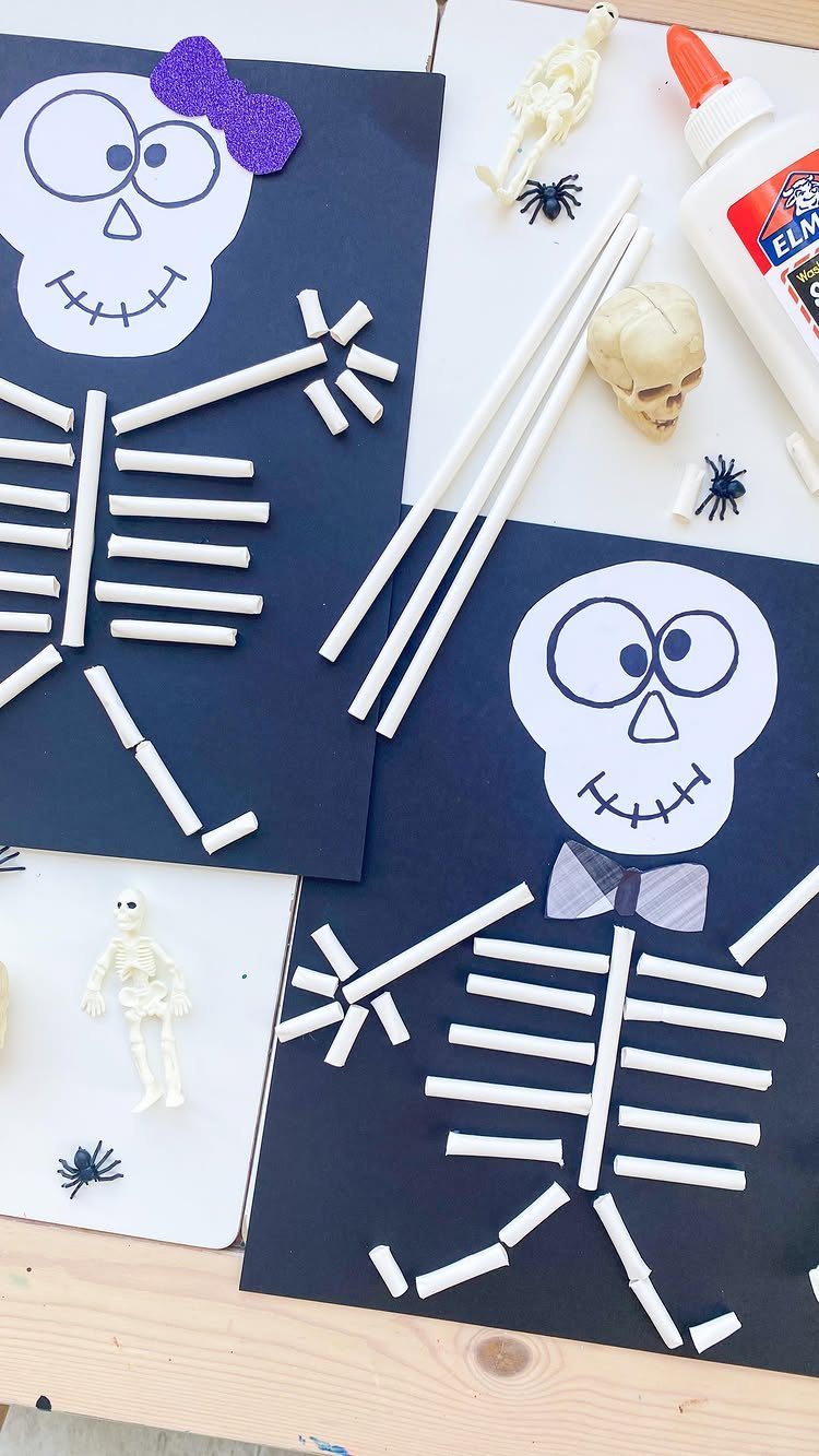 Skeleton crafts made from white straws and paper on dark blue backgrounds.