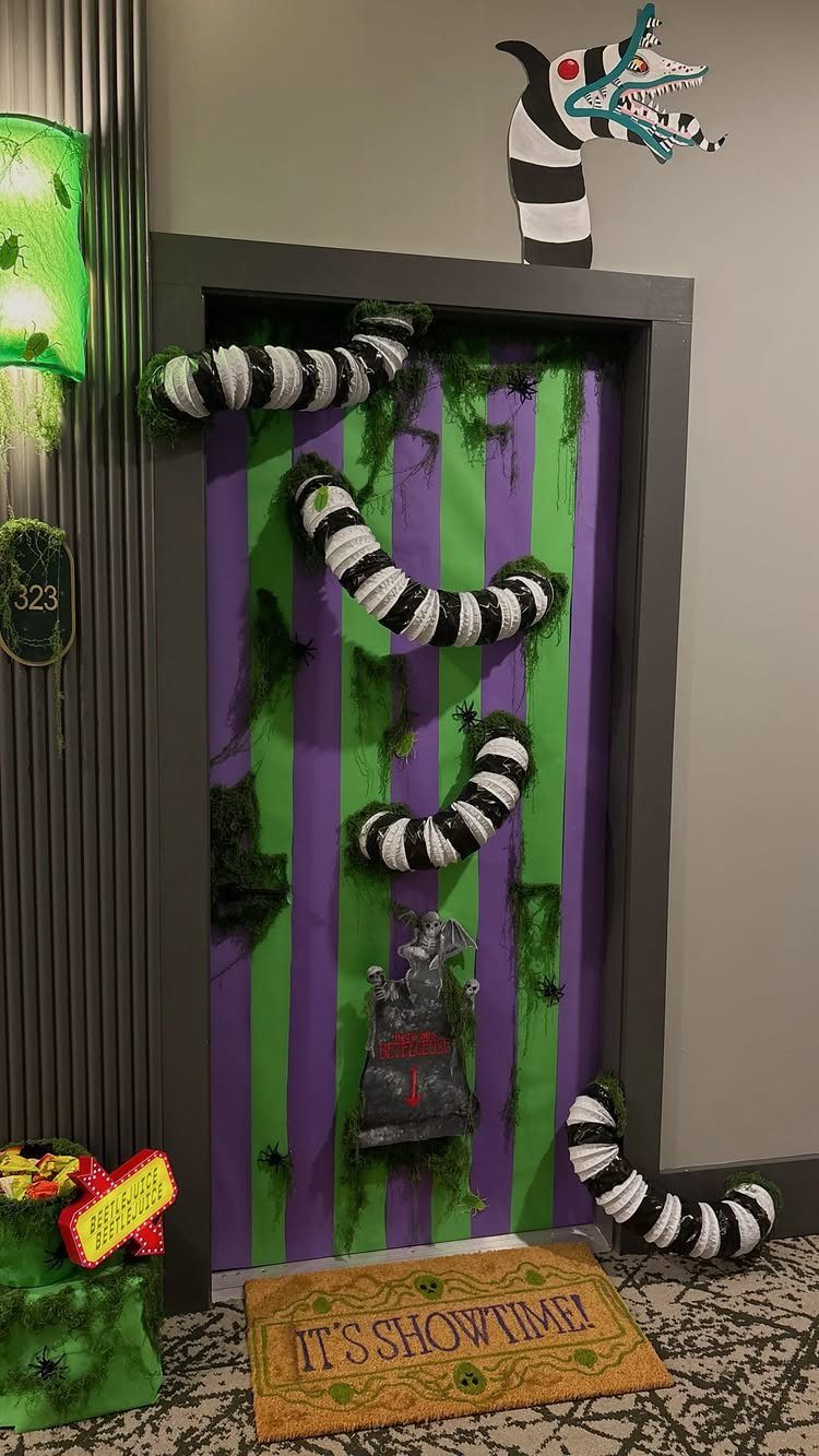 Halloween decorated door with purple and green stripes and a large striped serpent.
