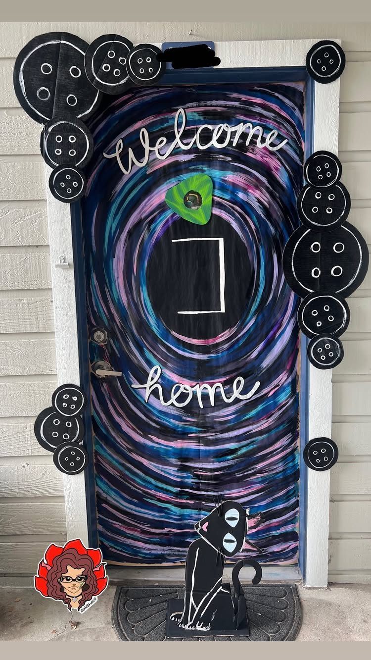 Galaxy painted door with large black buttons and a black cat cutout decoration.