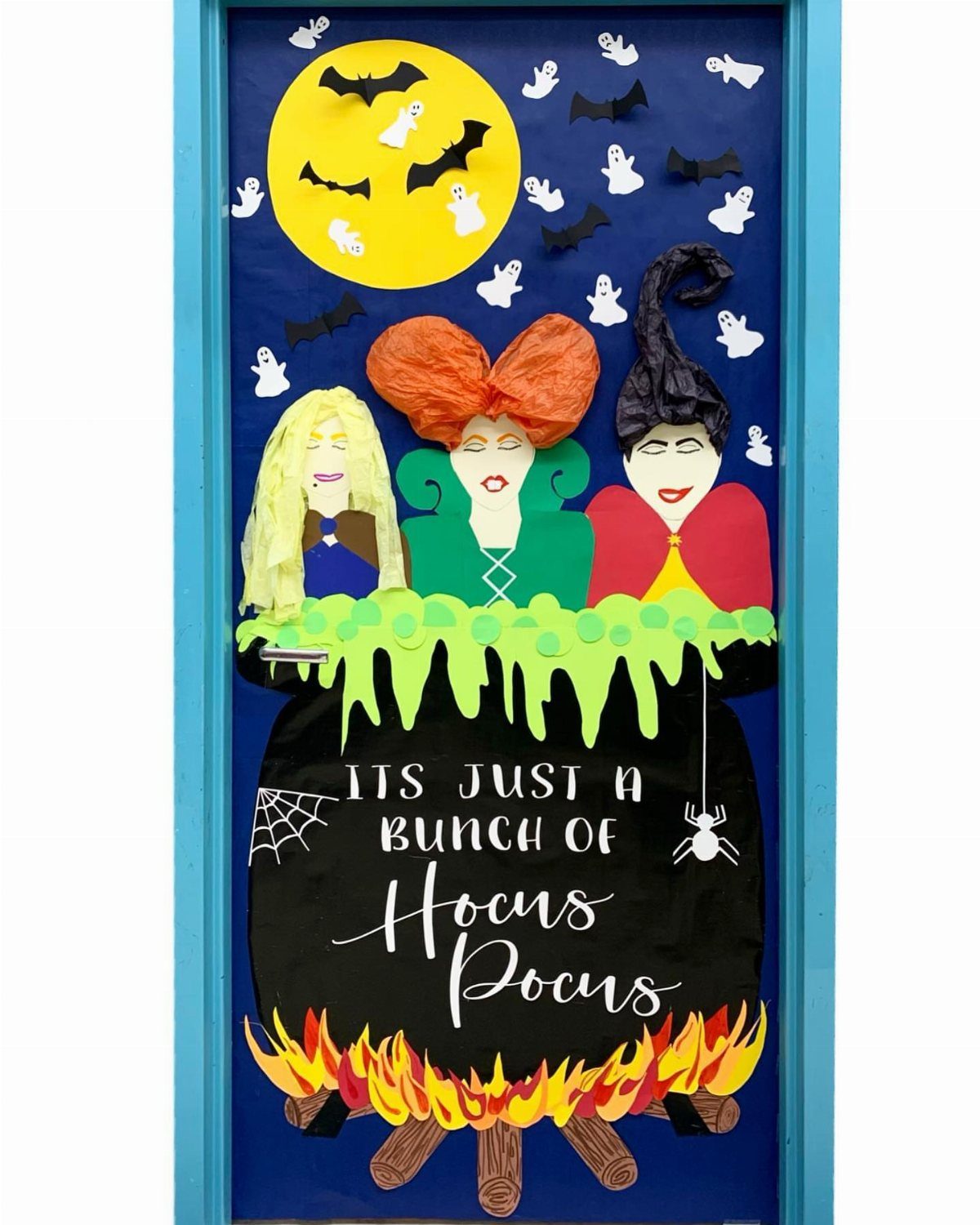 Hocus Pocus themed door decoration with three witches and a bubbling cauldron