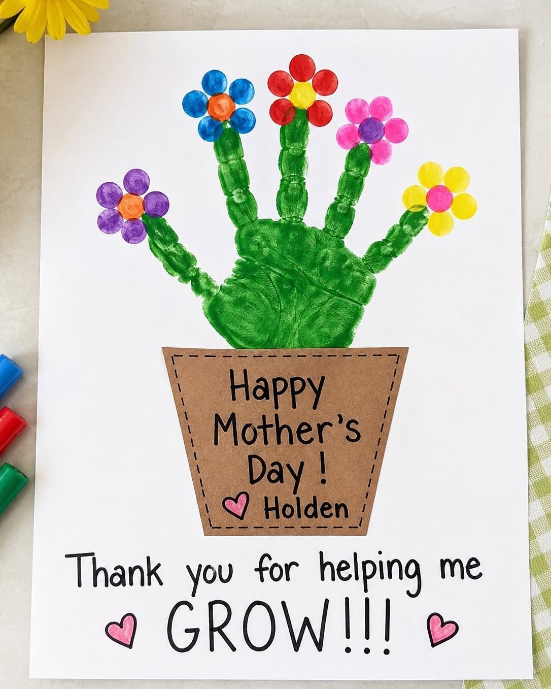 Handprint flower card with thumbprint petals in a pot for Mother's Day.
