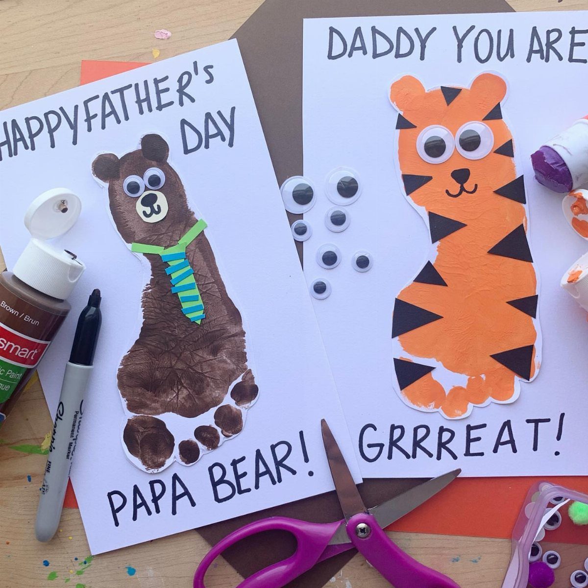 Two handmade Father's Day cards featuring a bear and a tiger with craft supplies.