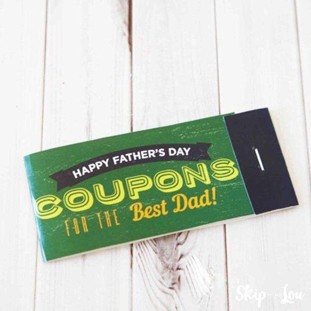 Green Father's Day coupon book for dad resting on a white wooden background.