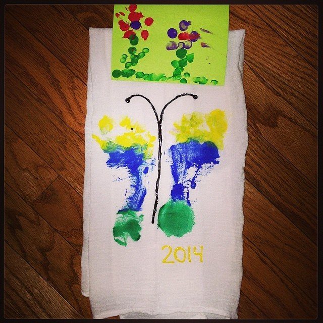 Handprint butterfly on a white towel with a small painted flower card.