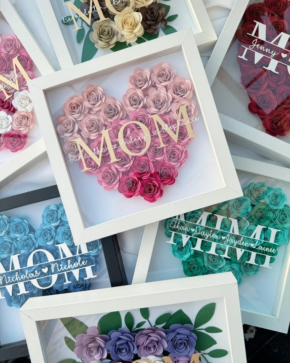 Heart-shaped paper rose arrangements in shadow box frames with personalized text for Mom.