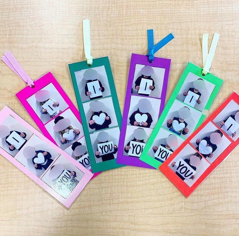 Colorful handmade bookmarks with photos of a child spelling I love you.