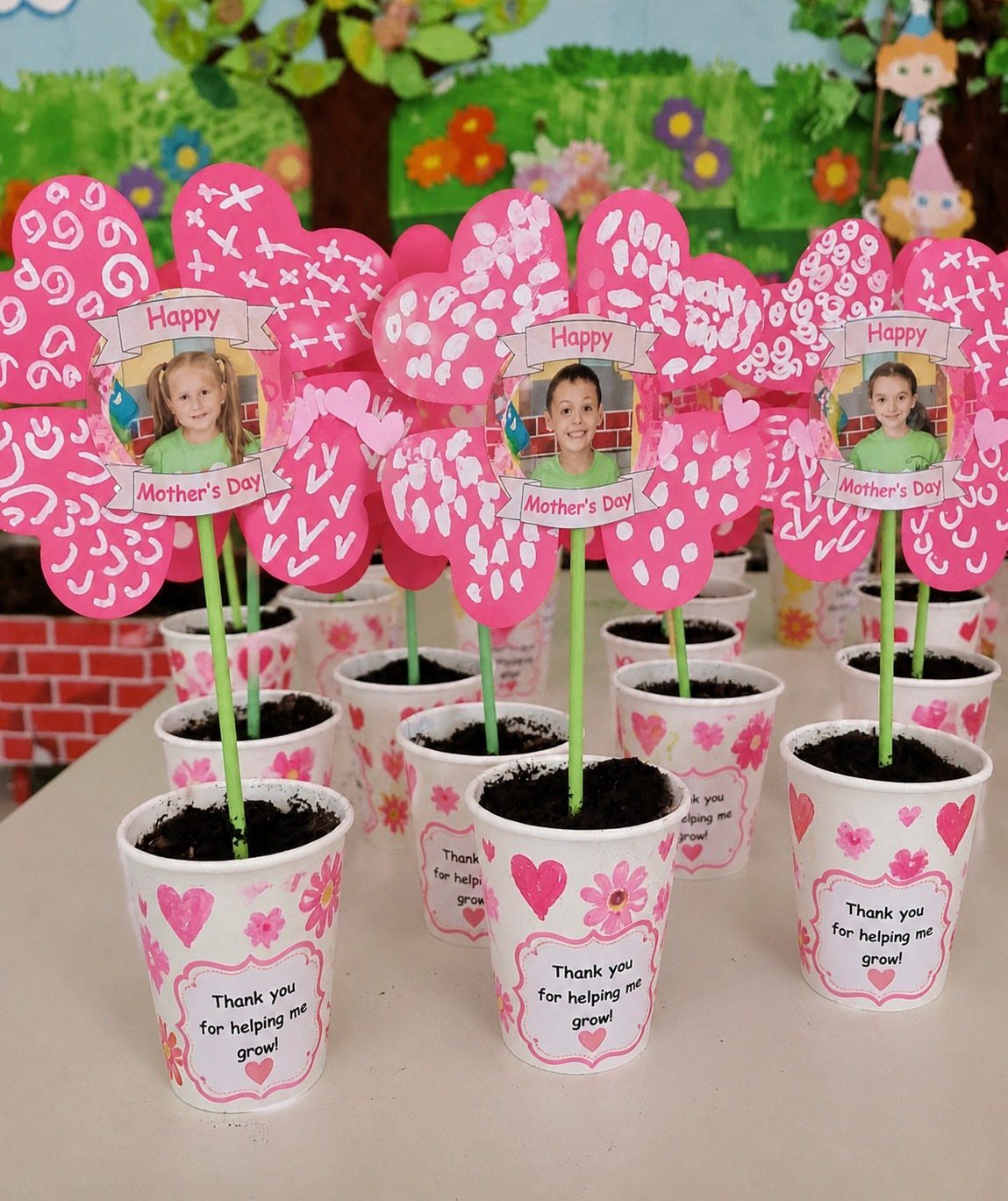 Decorated white paper pots with pink hearts and personalized flower photo toppers.