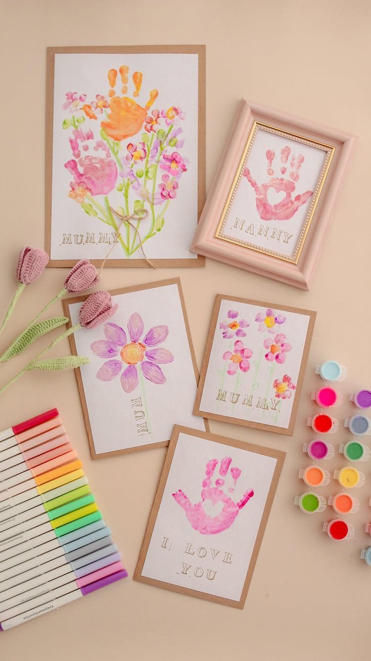 Handmade Mother's Day cards and a framed print featuring colorful handprints and flowers.