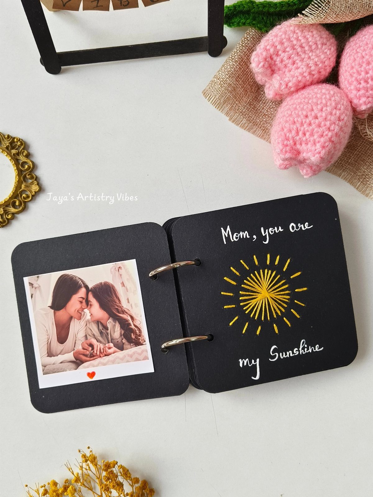 Handmade black Mother's Day book with a photo and yellow sun drawing.