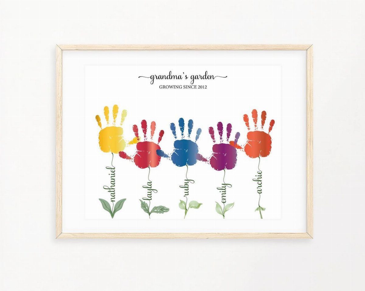 Framed artwork of colorful child handprints as flowers titled grandma's garden.