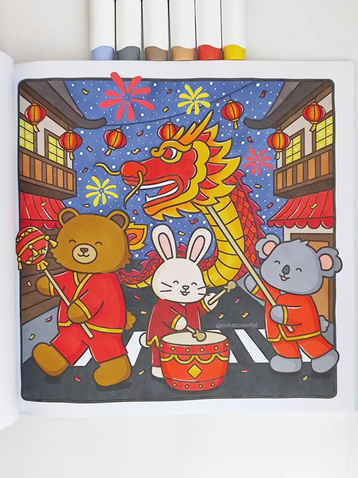 Colored drawing of animals in traditional Chinese dress with a dragon and lanterns.